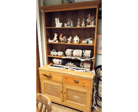A stripped pine kitchen dresser with shelf back, drawers and cupboards under 4' wide 