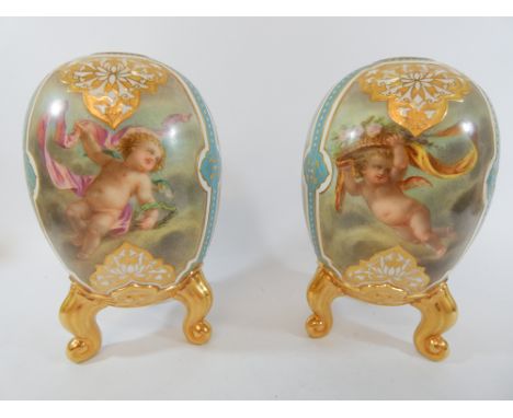 A pair of royal Worcester oviform vases, well decorated with three painted panels within jewelled turquoise and gilt borders,