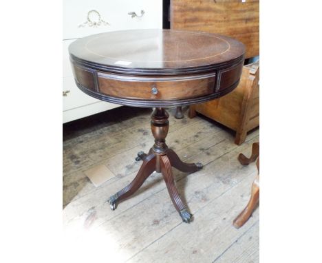 A circular reproduction mahogany drum table style coffee table on tripod base  