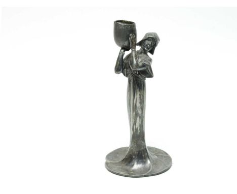 An Art Nouveau bronzed spelter figural candlestick, modelled as a girl holding a pail, 21cms high.