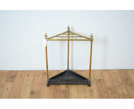 A 20th Century brass corner stick stand, with finials to each support, raised on a cast metal drip tray, 50 x 30 x 63cm high.