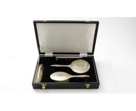 A silver mounted dressing table set by Broadway &amp; Co., Birmingham 1994, comprising hand brush, clothes brush, hand mirror