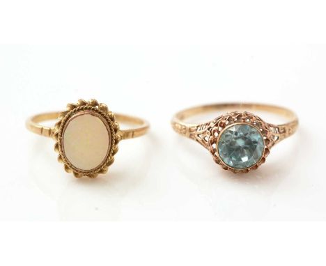 A zircon ring, the shank stamped 10k, ring size R, and an opal ring in 9ct gold mount and shank, ring size O, 3.5g gross.  