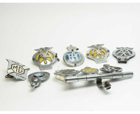 A collection of vintage car mascots, including: enamelled MG Car Club mascot; enamelled RAC car mascot; pair of AA car mascot