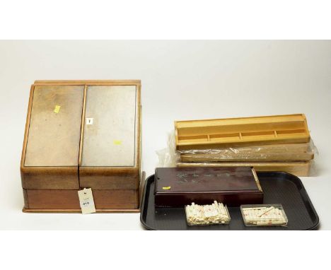 An early 20th Century burr walnut correspondence box, the twin hinged doors opening to reveal perpetual calendar, letter rack