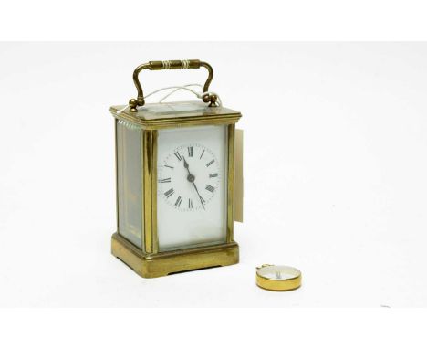 A 19th Century French brass carriage clock, white enamel Roman dial, with platform lever escapement, 14.5cms high including h