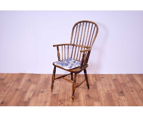 A 19th Century ash and elm comb back Windsor chair, the spindle back rest, over shaped elbow rests, the saddle seat, raised o