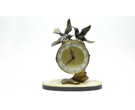 A French Art Deco style brass mantel clock, by Silvoz Paris, the circular Arabic gilt dial mounted with a pair of gilt detail