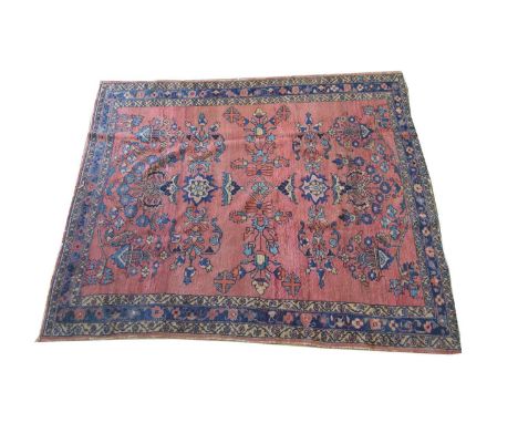 A Mohajeran carpet, with floral bouquets on red ground, 181 x 153cms.