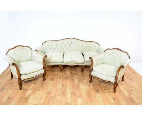 A 19th Century French walnut three-piece salon suite, each piece with arched and button back outward scrolling arms, on squat