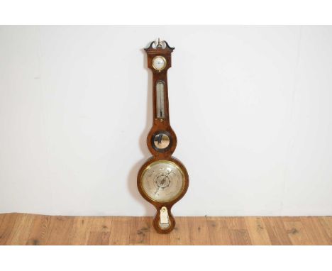 A 19th Century inlaid mahogany wheel aneroid barometer, marked L. Realini of Newcastle, the swan neck pediment with central f