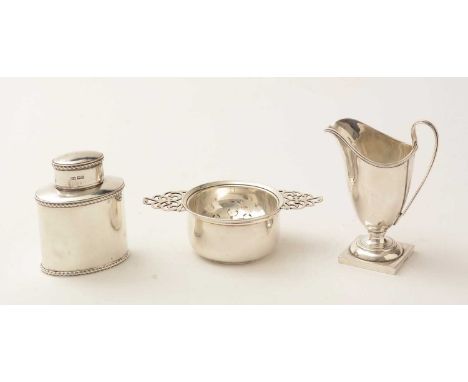 A silver tea caddy, by Harry Atkins, Sheffield 1913; a tea strainer on stand, by Elkington &amp; Co. Birmingham 1965; and a m