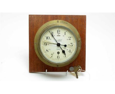 A Sestrel brass cased ships wall clock, inscribed ‘I.L. Holt Tønsberg’, 20cms diameter, mounted to a mahogany wall plaque.