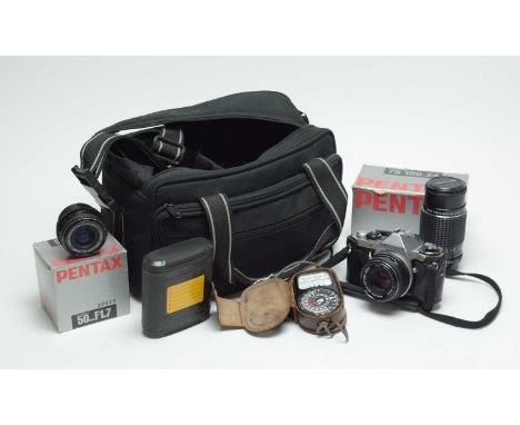 A Pentax ME Super camera, in carry case; together with two Pentax camera lenses, each in box; in camera bag.