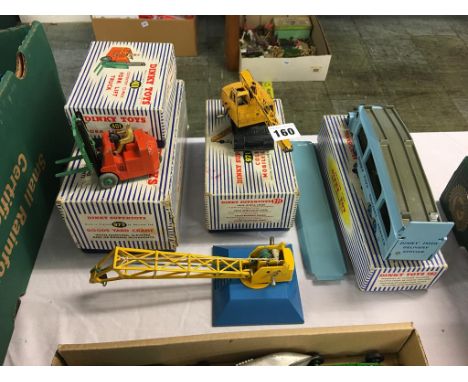 A boxed Dinky 401 fork lift truck, a 973 Goods Yard crane, a 971 Coles mobile crane and a 582 Pullmore car transporter, boxed