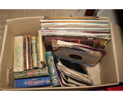 A box containing vintage books and records
