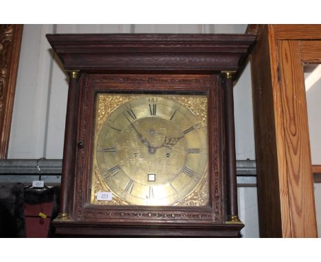 An Andrew Padbury Bishop Waltham grandfather clock having brass dial, eight day movement and profusely carved trunk