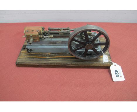 A Stuart Horizontal Cylinder Steam Engine, 3cm stroke, 9.5cm flywheel, fair condition, mounted to a wood base, 11 x 26cm.