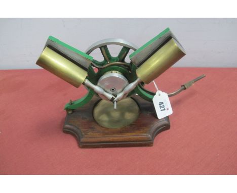 A Live Steam "Vee" Twin Cylinder Engine, 12cm diameter flywheel, finished overall green and bright metal, mounted to a wood b