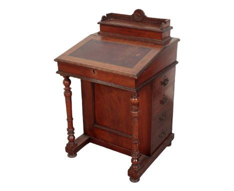 A LATE VICTORIAN WALNUT DAVENPORT 19th century, the galleried shelf to the top opens to a fitted interior, the sloped front w