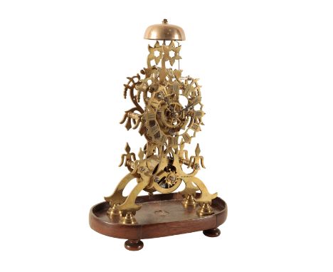 A VICTORIAN SKELETON CLOCK the single chain fusee movement striking on a bell, standing on a wooden plinth, 32cm high