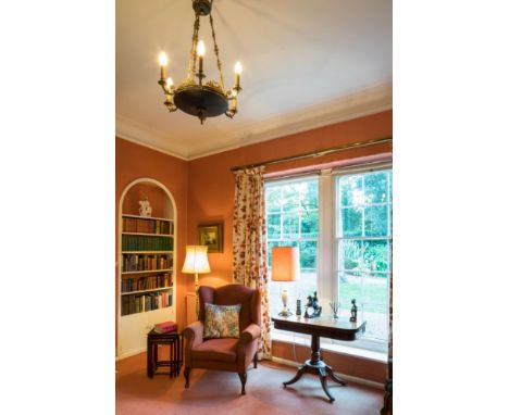 A REGENCY MAHOGANY TEA TABLE the hinged top with a gadrooned edge, on a turned column to quatreform base, 78cm high x 100cm w