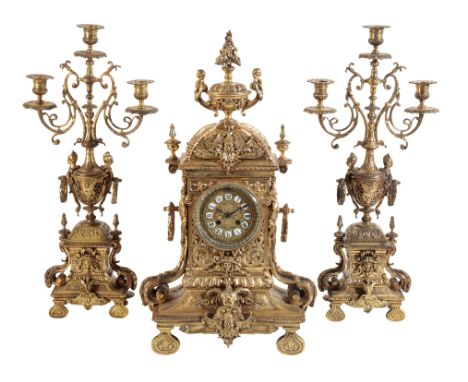 A FRENCH GILT BRASS CASED CLOCK GARNITURE the 12cm clock dial with porcelain tablet Roman numerals, the two train movement st