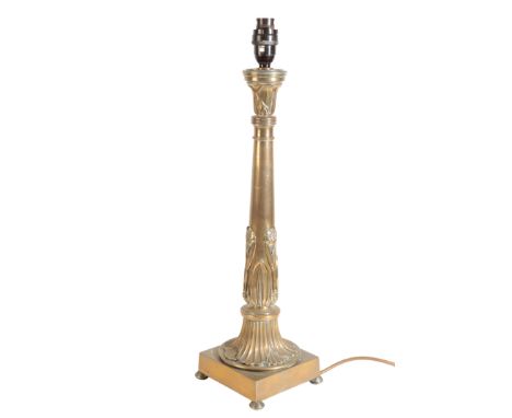 A BRONZE TABLE LAMP BASE Circa 1840, the tapering shaft decorated with flowers in relief, on a square base terminating in com