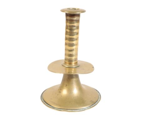 A CHARLES II BRASS TRUMPET CANDLESTICK Circa 1680, of ribbed form with drip pan and spreading circular base, 15cm high