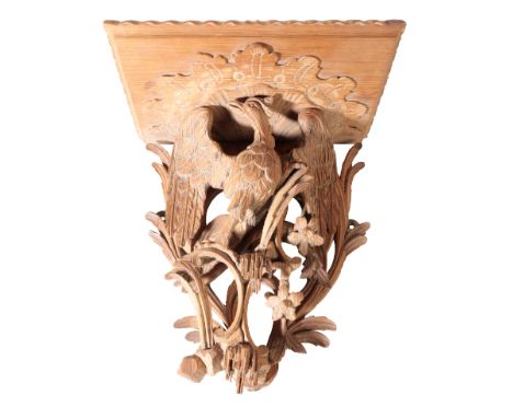 A GEORGE II CARVED SOFTWOOD WALL BRACKET probably 18th century, the square shelf above a bird amongst flowers and foliage, 33