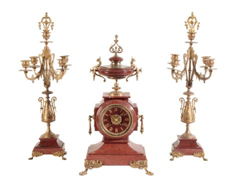 A FRENCH MARBLE &amp; BRASS CLOCK GARNITURE the 10cm marble dial, with Roman numerals, the two train movement striking on a b