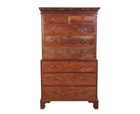 A LATE GEORGE III MAHOGANY CHEST ON CHEST Circa 1790, with a dentil cornice and a carved frieze, above two short and three lo
