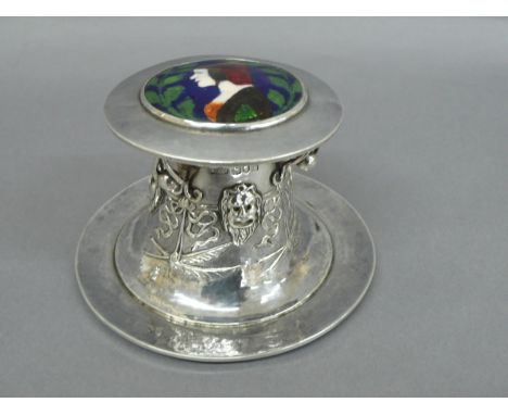 Omar Ramsden &amp; Alwyn C E Carr - A Capstan shaped silver inkwell with enamel decoration of a woman in a red bonnet to top.