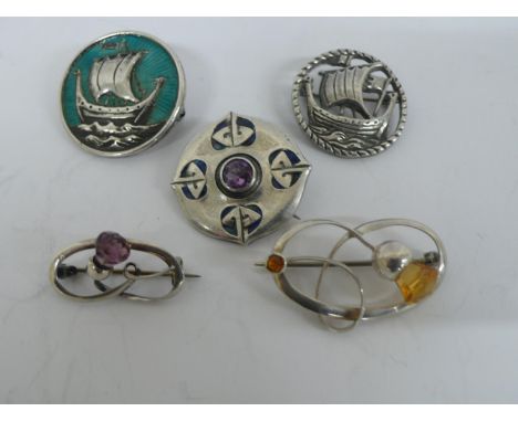 Five Art Nouveau and late silver brooches some with enamel or semi precious stones by Charles Horner or William Darby 