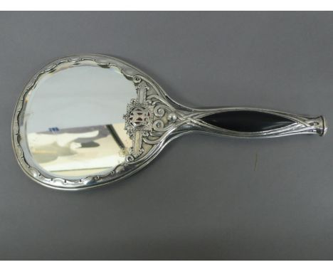 Omar Ramsden - Silver, ebony and red enamel hand held mirror with decoration of flower petal border and entwined stems, appli