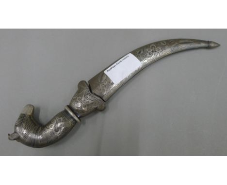 A 19th century Persian knife, the steel scabbard and grip inlaid with silver, the grip in the form of a horse's head, the bla