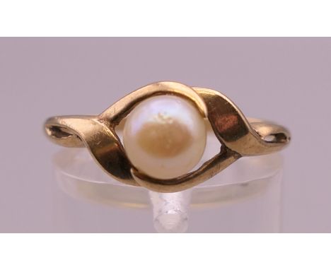 A 9 ct gold and pearl ring. Ring size P/Q. 2.2 grammes total weight.