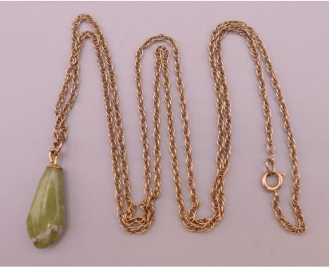 A jade pendant on an unmarked gold chain. The pendant 2.5 cm high.