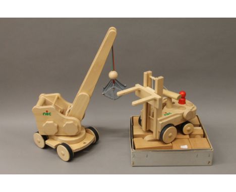 Two boxed Nic wooden toys, a crane and a fork lift, and a set of wooden building blocks.