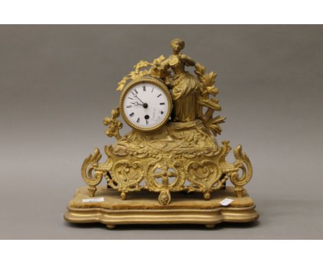 A Victorian gilt spelter mantle clock on a plinth base. 33 cm high.