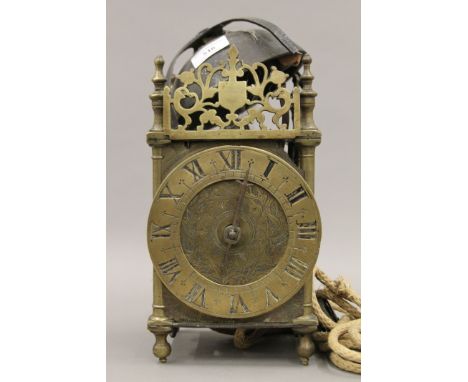An antique lantern clock. Approximately 33 cm high.