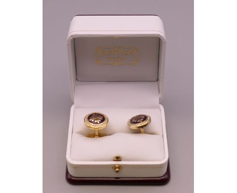 A pair of Patek Philippe cufflinks in a Penrose of London box.
