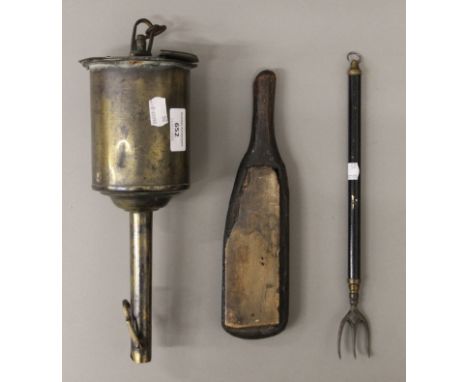 A brass spit jack, a leather makers tool and a toasting fork. 