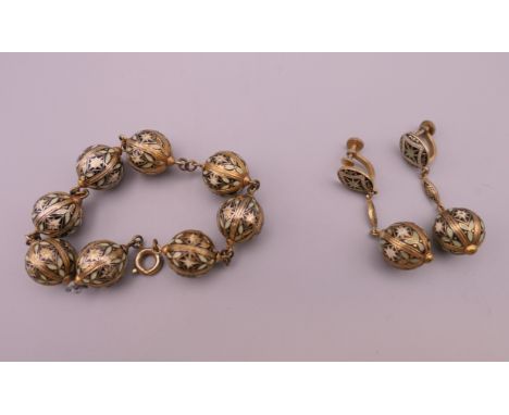 An Eastern enamel decorated bracelet and earrings. The bracelet 19 cm long.