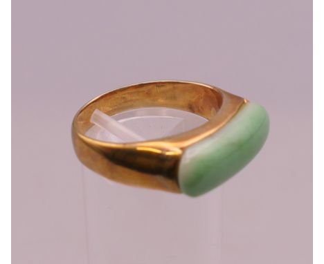A suite of gold mounted jade jewellery. The necklace approximately 50 cm long, ring size S/T.
