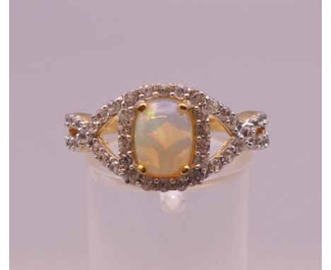 A silver opal and cubic zirconia ring. Ring size Q. 