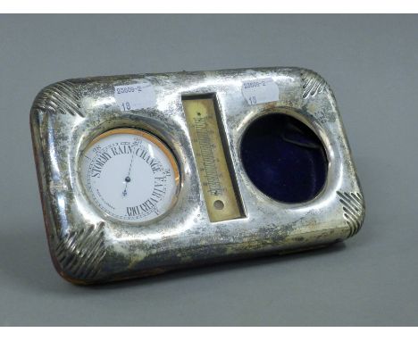 A silver plated barometer set in a silver case (case lacking watch). 19.5 cm wide. 