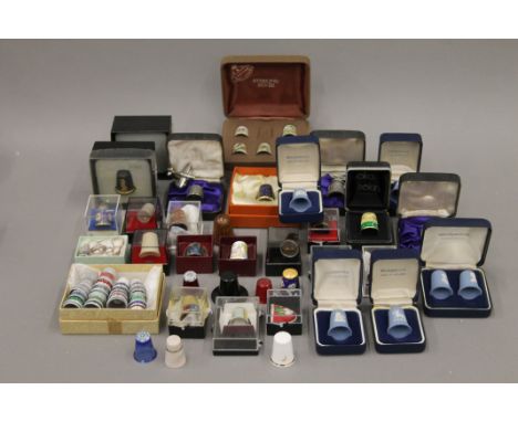 A quantity of various enamel and porcelain thimbles.