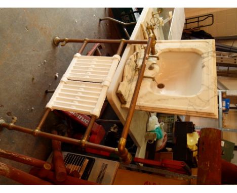 Ceramic sink in a marble surround with splashback and brass fittings and brass short front legs 