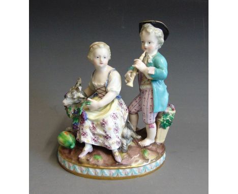 A Meissen figure group of a boy and girl representing Autumn, with a goat harvesting on grapes, carly 19th Century, blue cros